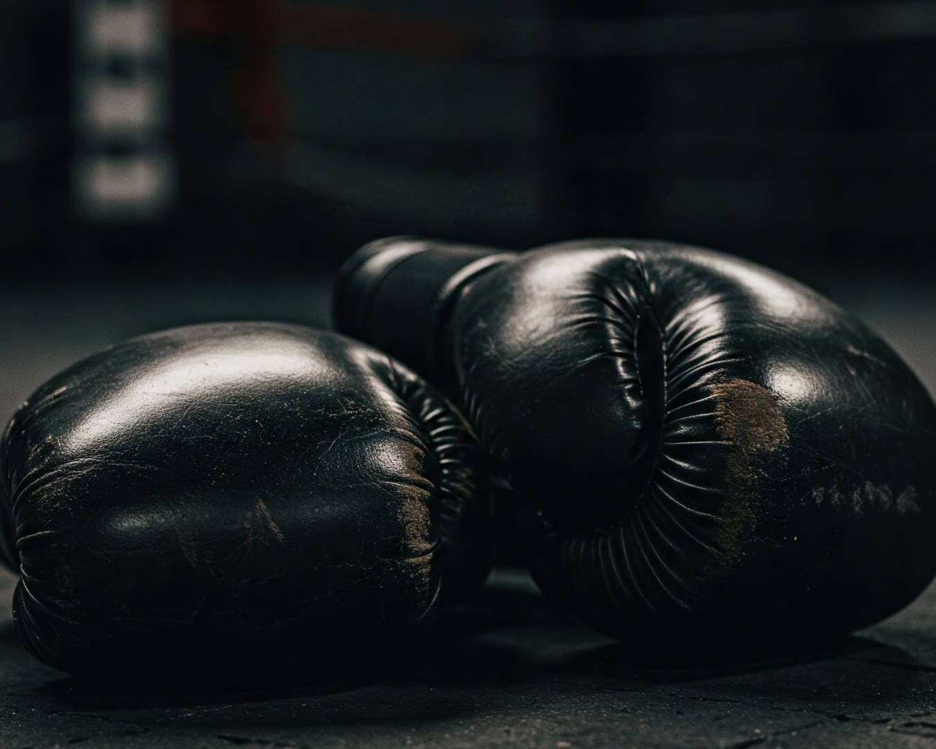 Image of two boxing gloves on the ground after a hard training session